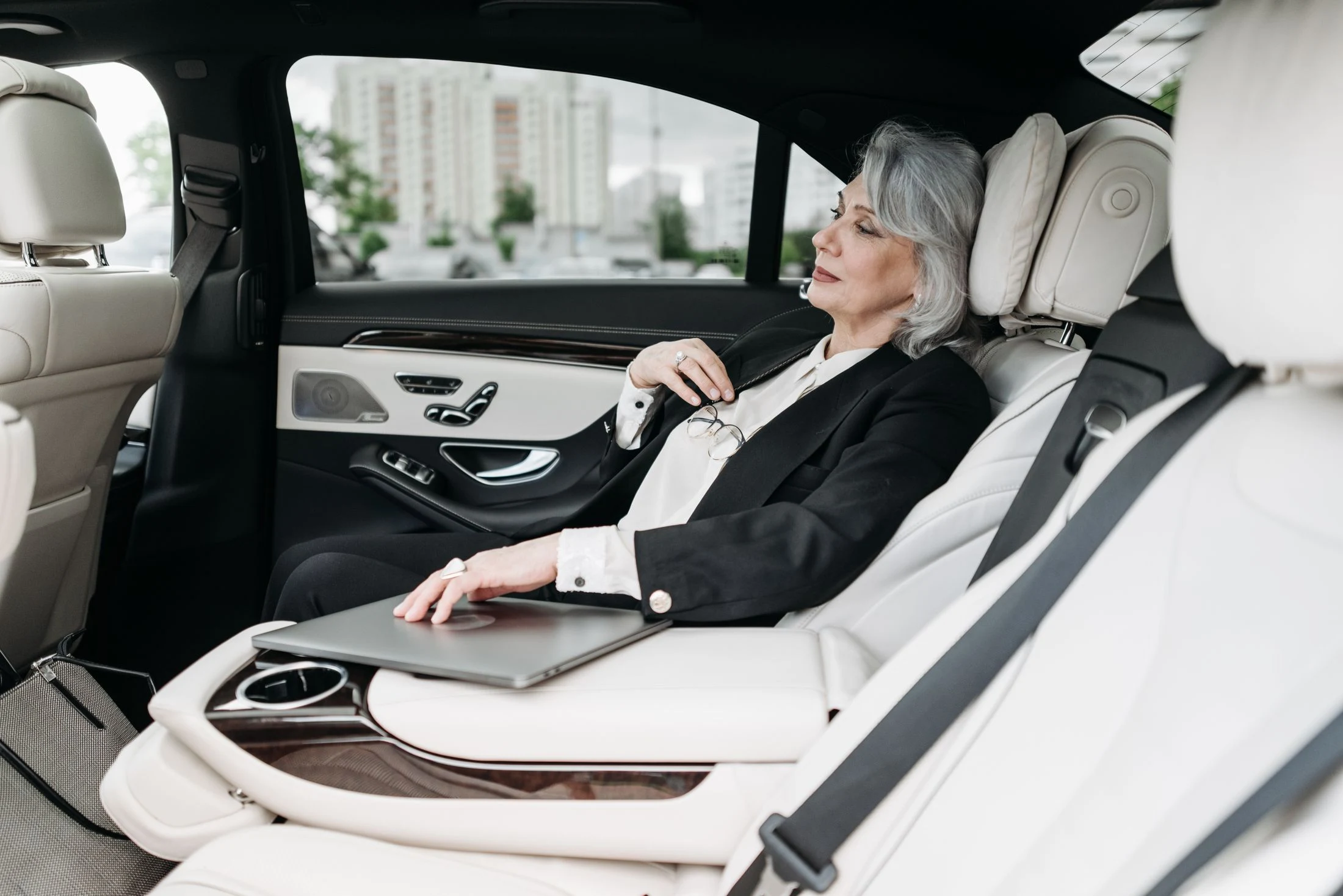 Executive traveller seated in the rear of a chauffeured car